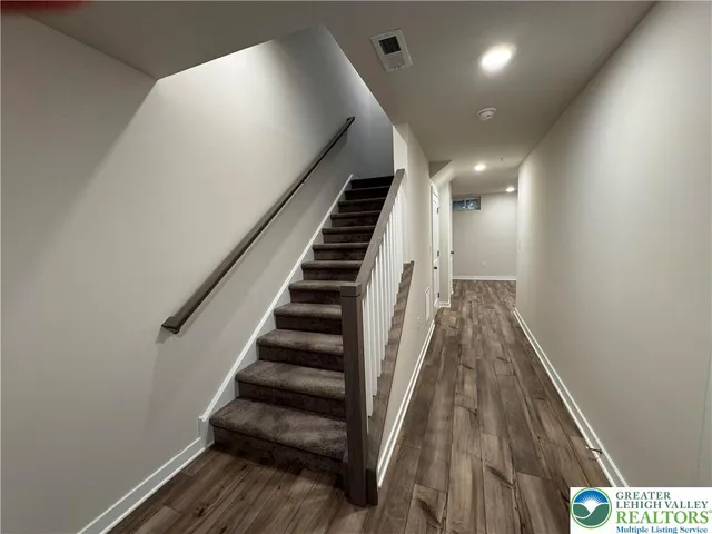 a view of entryway and hall with wooden floor