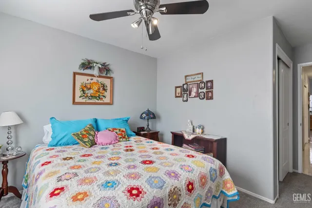 a bedroom with bed and painting on the wall