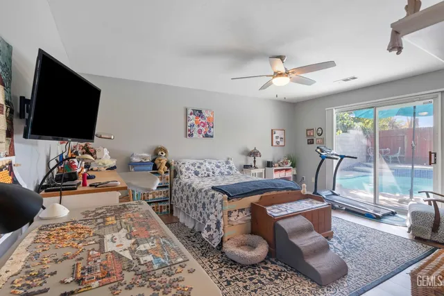 a living room with furniture a flat screen tv and a chandelier