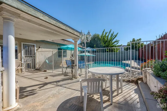 a view of a chair and tables in the balcony