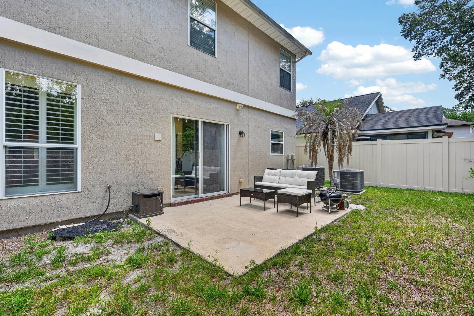 1237 Splendid Ravine Street St. Augustine, FL 32092 - Photo 30 of 62 a backyard of a house with table and chairs