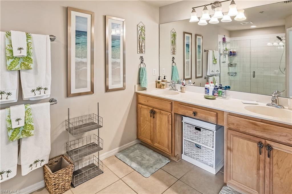 16211 Ravina Way, Unit 18 Naples, FL 34110 - Photo 13 of 24 a spacious bathroom with a sink double vanity and a mirror