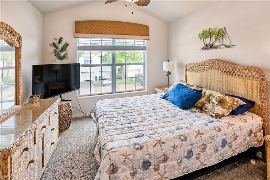 16211 Ravina Way, Unit 18 Naples, FL 34110 - Photo 16 of 24 a bedroom with a bed and a flat screen tv