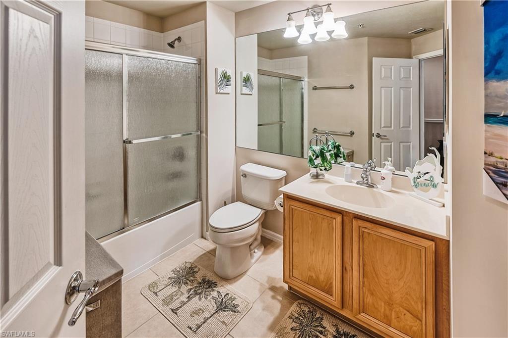 16211 Ravina Way, Unit 18 Naples, FL 34110 - Photo 17 of 24 a spacious bathroom with a toilet sink and a mirror