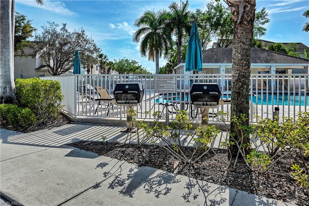 16211 Ravina Way, Unit 18 Naples, FL 34110 - Photo 22 of 24 a view of balcony with outdoor seating and plants