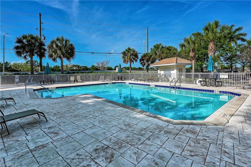 16211 Ravina Way, Unit 18 Naples, FL 34110 - Photo 23 of 24 a swimming pool with outdoor seating and yard