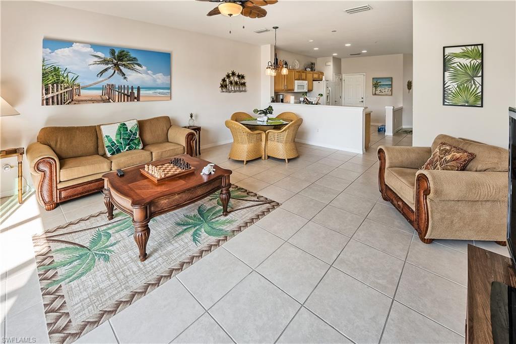 16211 Ravina Way, Unit 18 Naples, FL 34110 - Photo 5 of 24 a living room with furniture and a painting