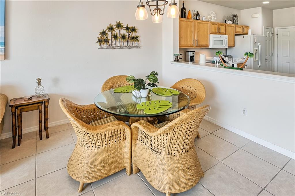 16211 Ravina Way, Unit 18 Naples, FL 34110 - Photo 6 of 24 a dining room with furniture and wooden floor