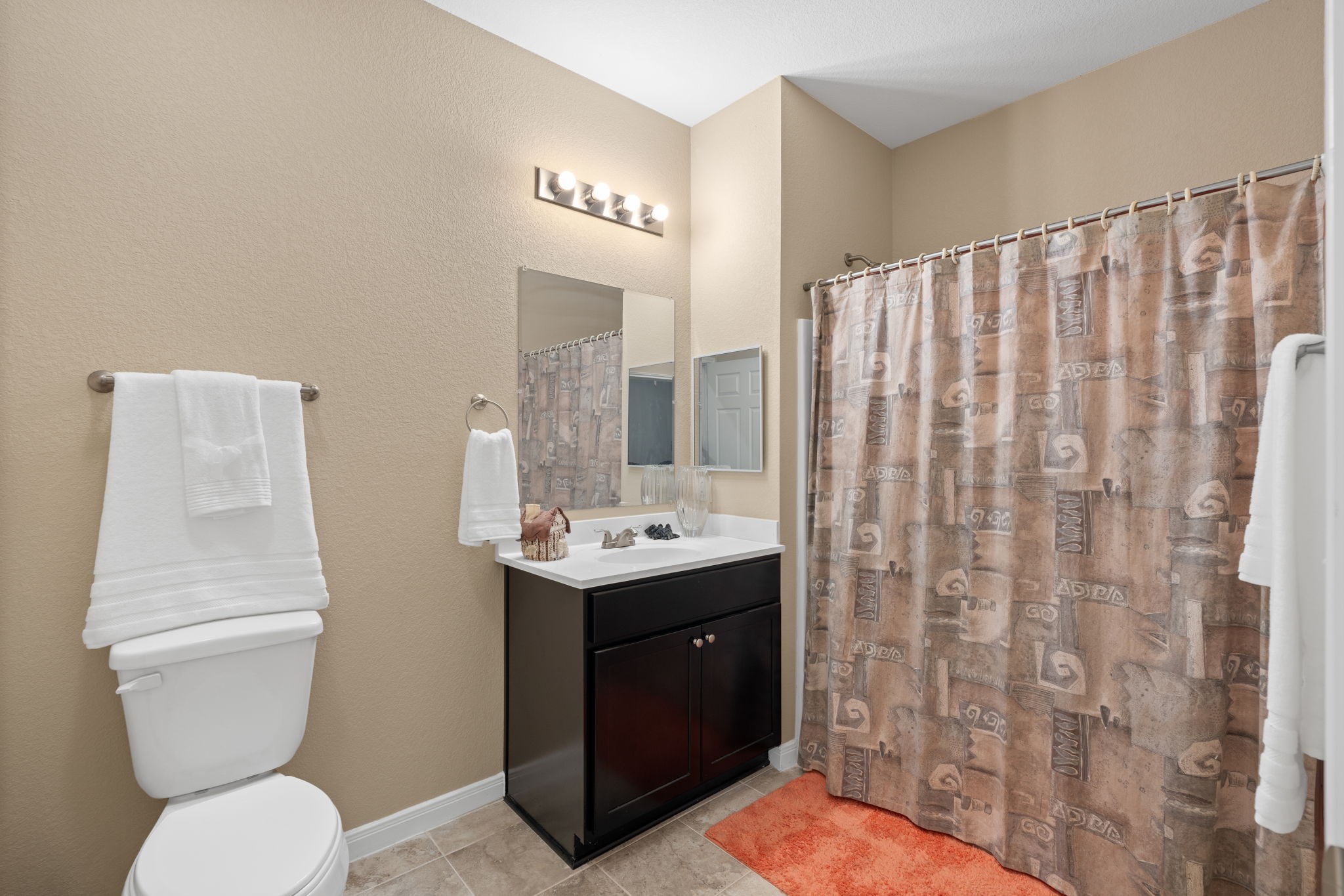 11706 Bogs Court Tomball, TX 77375 - Photo 19 of 42 a bathroom with a toilet sink and mirror