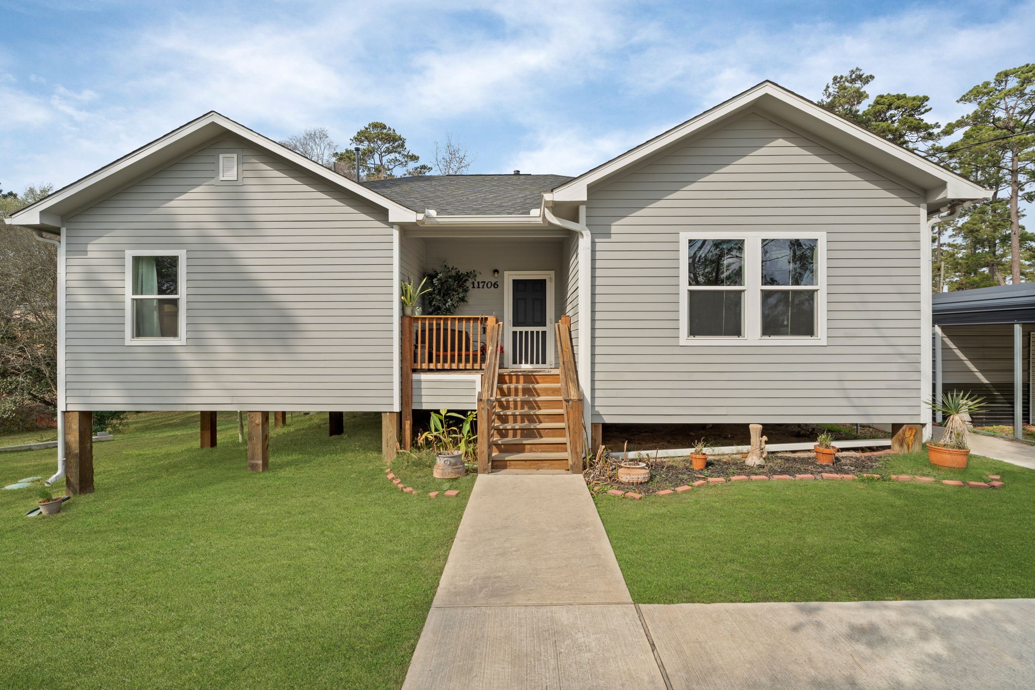 11706 Bogs Court Tomball, TX 77375 - Photo 2 of 42 a front view of a house with a yard and outdoor seating