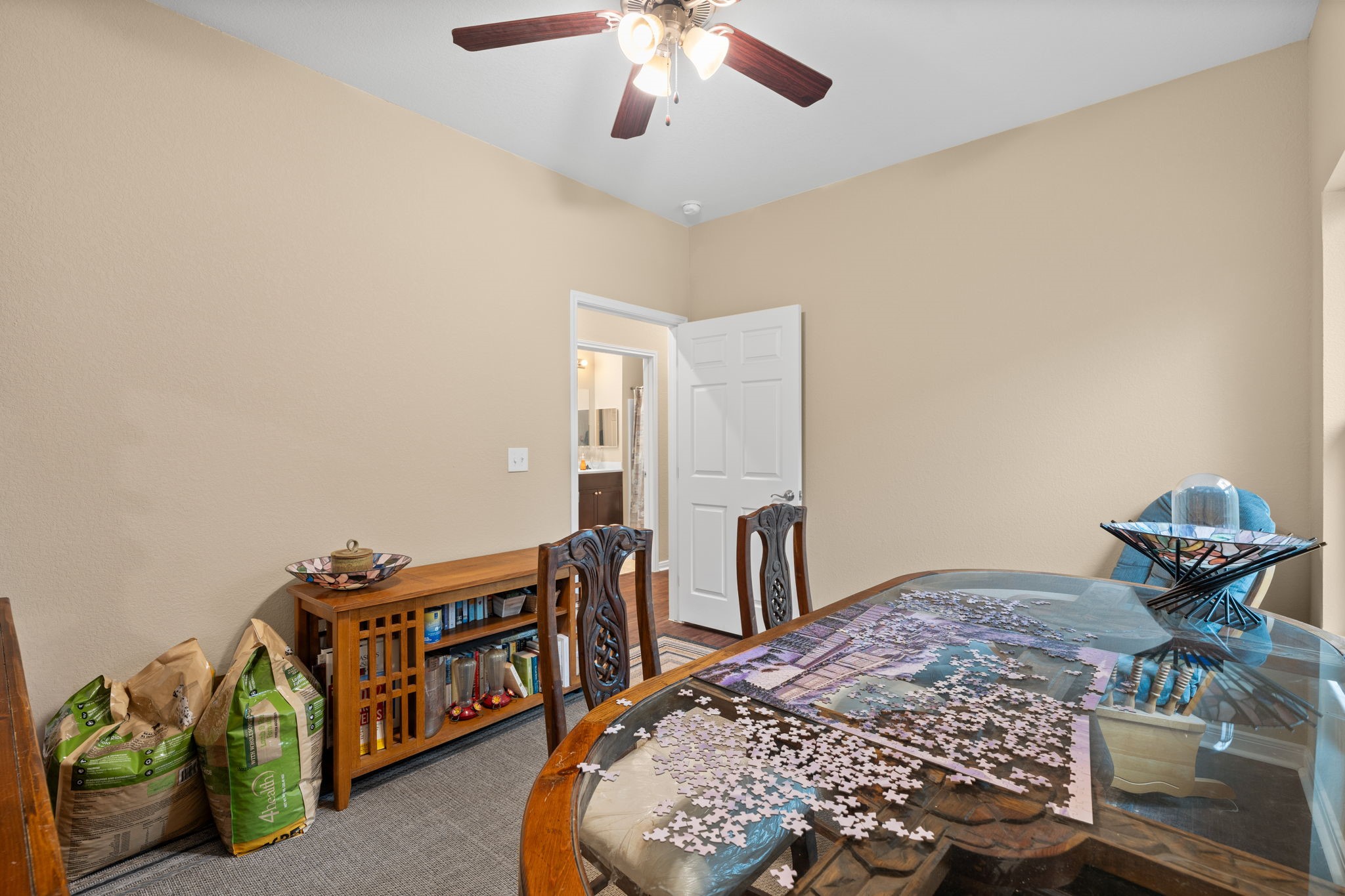 11706 Bogs Court Tomball, TX 77375 - Photo 22 of 42 a bedroom with furniture and a chandelier