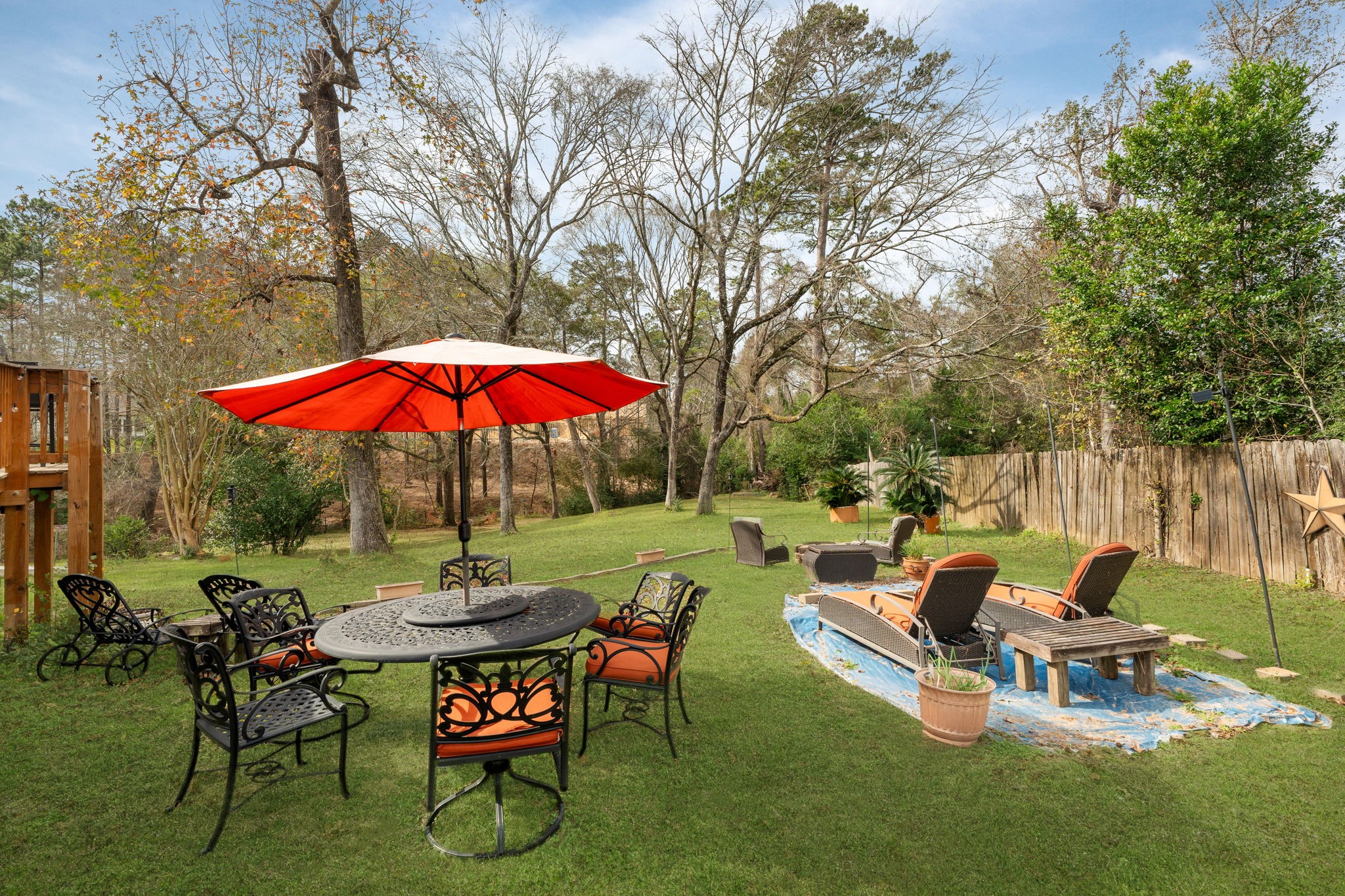 11706 Bogs Court Tomball, TX 77375 - Photo 34 of 42 an outdoor sitting area with furniture and umbrella