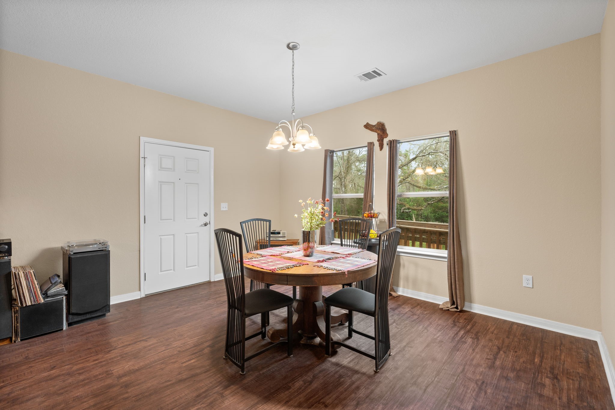11706 Bogs Court Tomball, TX 77375 - Photo 10 of 42 a dining room with furniture a chandelier and wooden floor