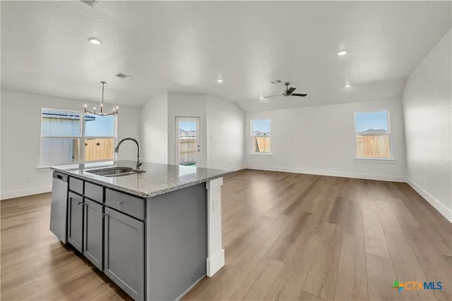 an empty room with wooden floor and window