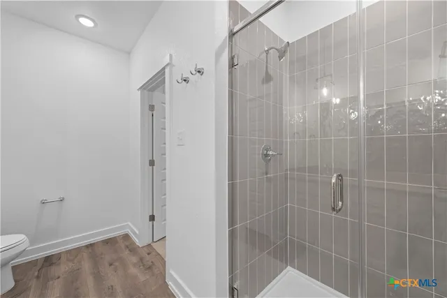 an empty room with a window and ceiling fan