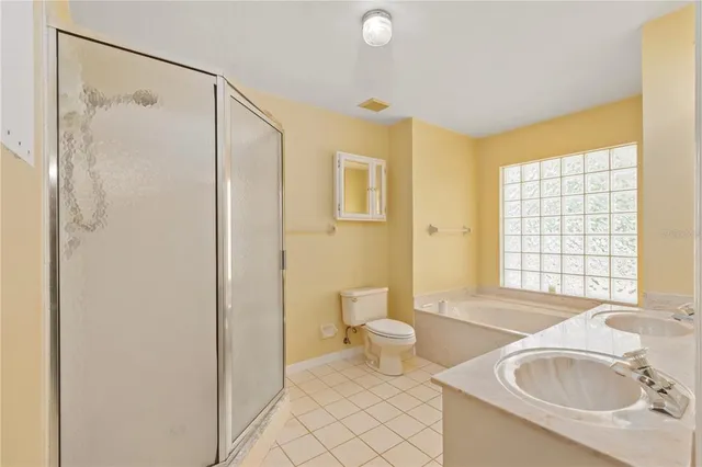 a bathroom with a granite countertop sink and a bathtub