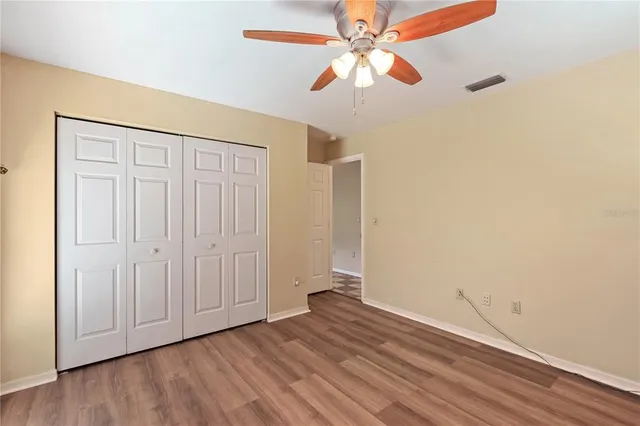 a view of a room with a fan and a window