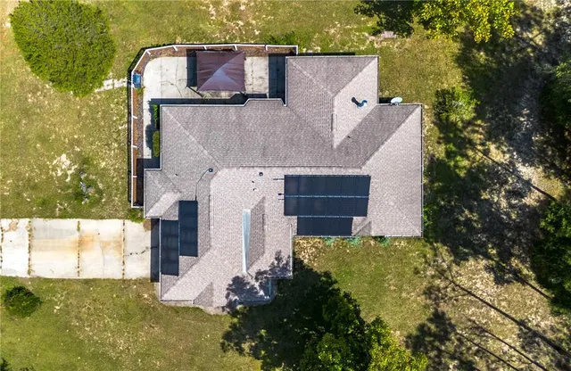 an aerial view of a house with a yard