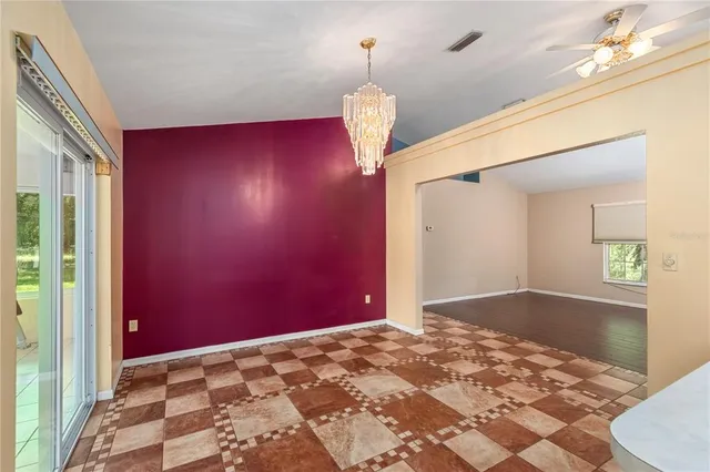a kitchen with white cabinets and appliances