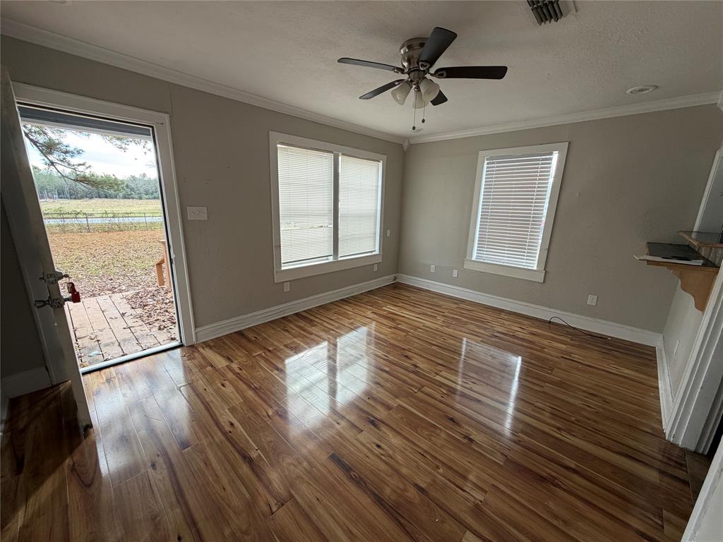 2240 Pin Oak Circle Haughton, LA 71037 - Photo 2 of 10 a view of an empty room with wooden floor and a window