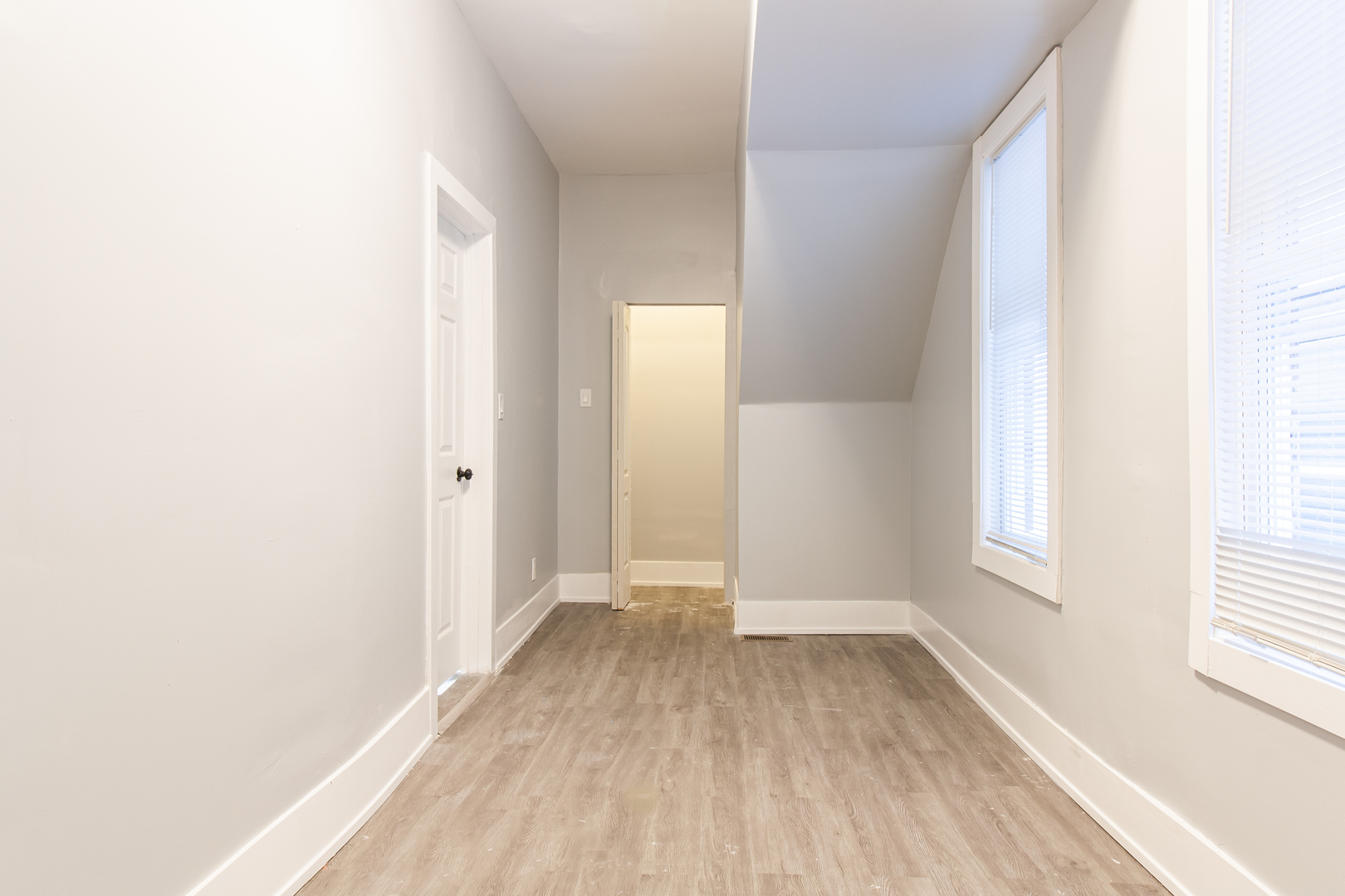 2659 West Homer Street, Unit 1F Chicago, IL 60647 - Photo 12 of 14 a view of hallway with window and wooden floor