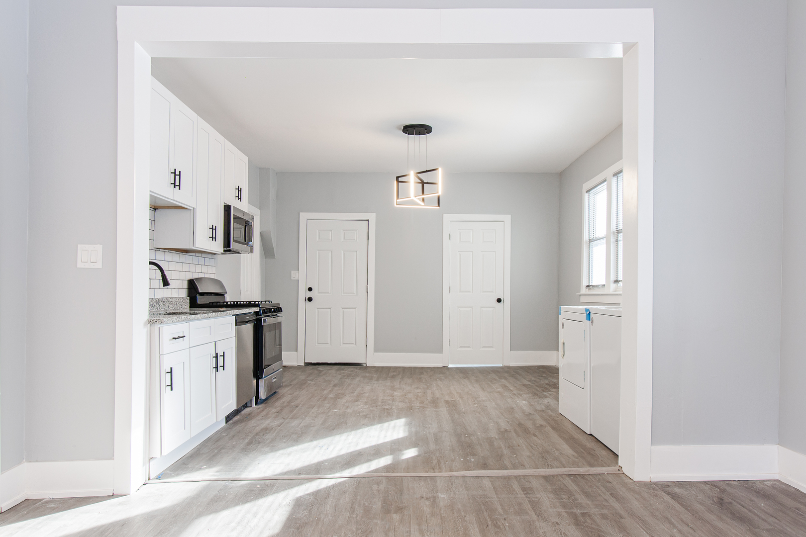 2659 West Homer Street, Unit 1F Chicago, IL 60647 - Photo 5 of 14 a view of a kitchen with a sink dishwasher stove and cabinets