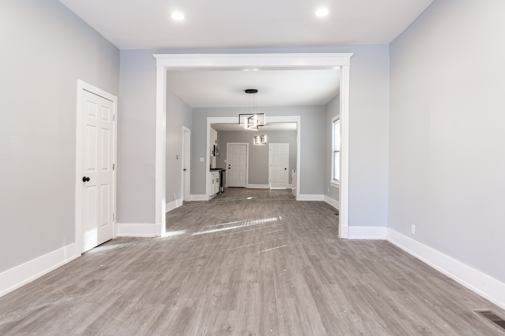 2659 West Homer Street, Unit 1F Chicago, IL 60647 - Photo 8 of 14 wooden floor in an empty room with a window