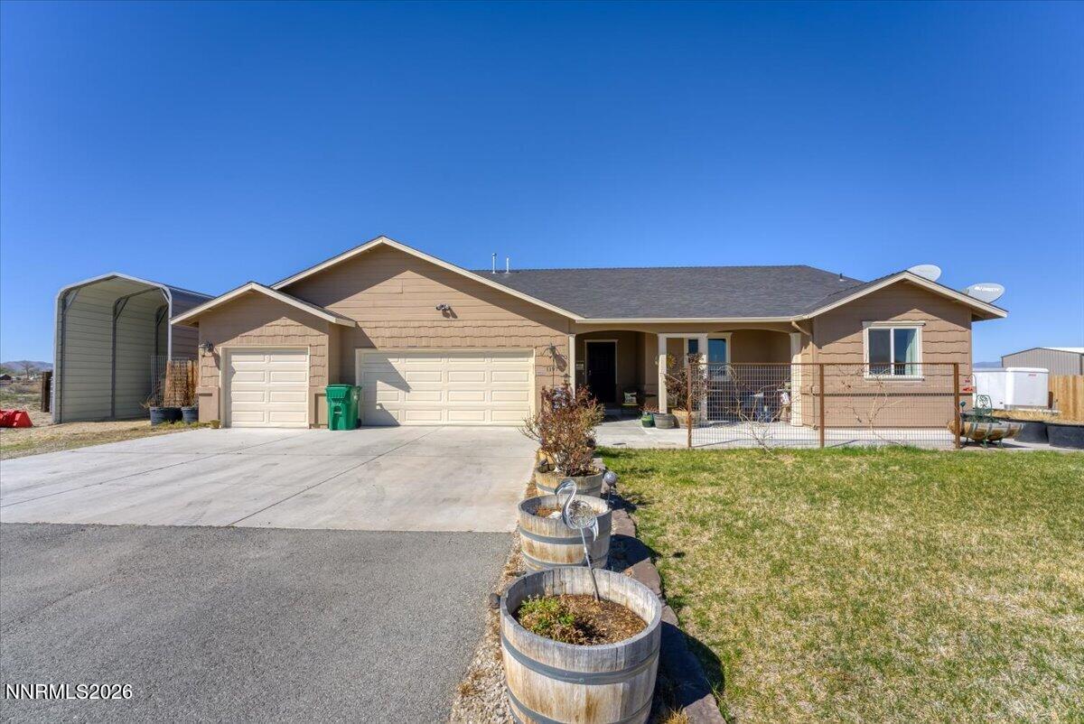 1197 Sky Ridge Drive Fallon, NV 89406 - Photo 5 of 79 a front view of a house with garden
