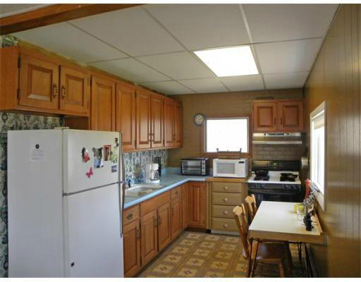 10 Willey Road Monroe, MA 01350 - Photo 6 of 18 a kitchen with a refrigerator and a stove top oven