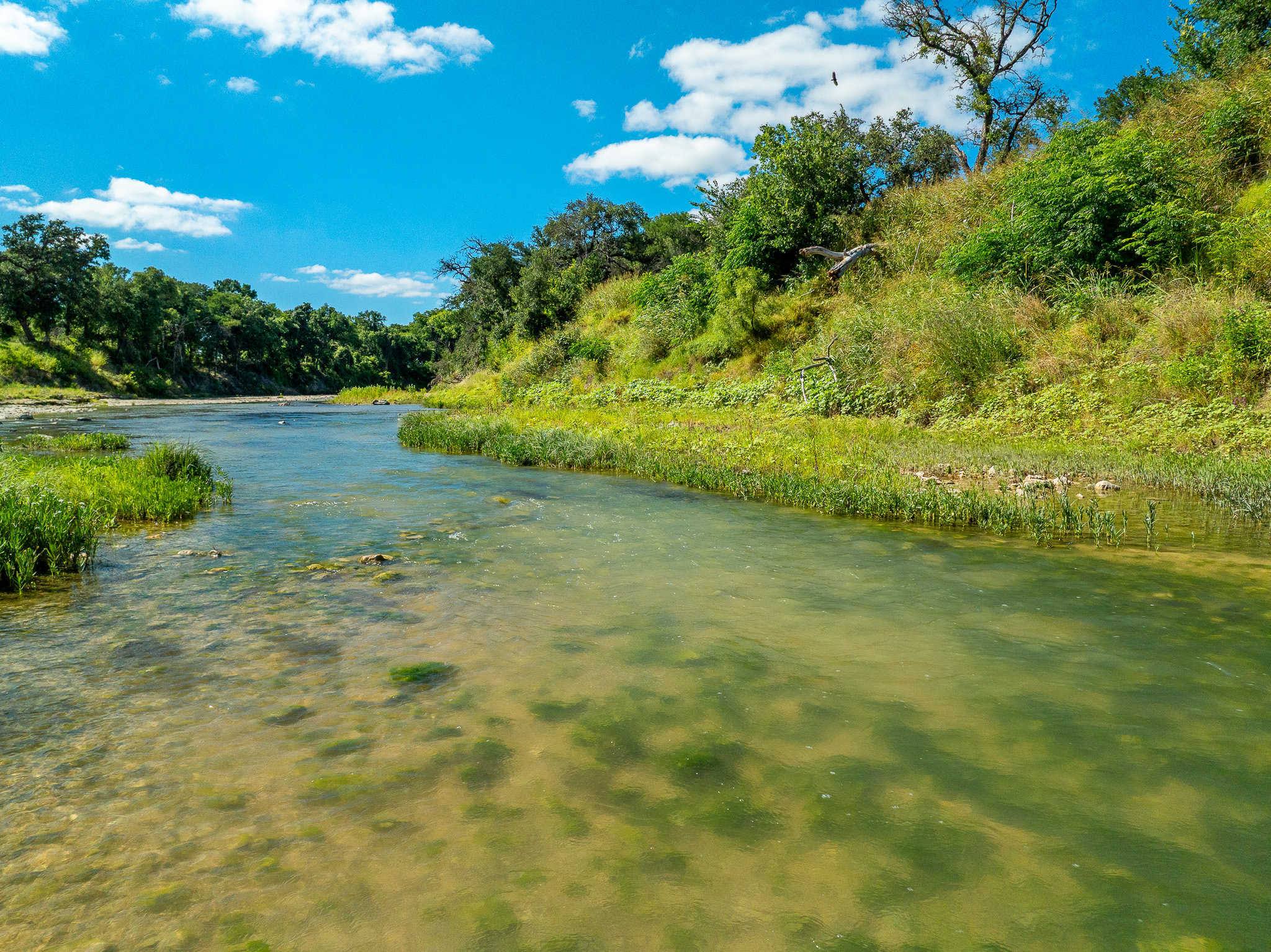 8044 580th Street East Kempner, TX 76539 - Photo 35 of 40 Clear waters flow gently through a verdant landscape under an open sky.