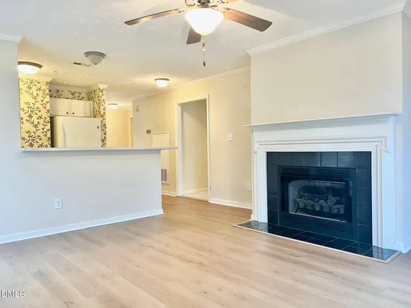 an empty room with a window and a ceiling fan
