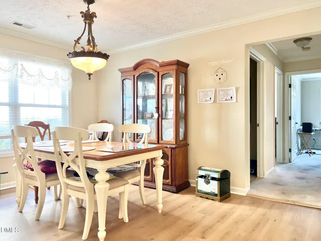 a view of a hallway with wooden floor and closet area