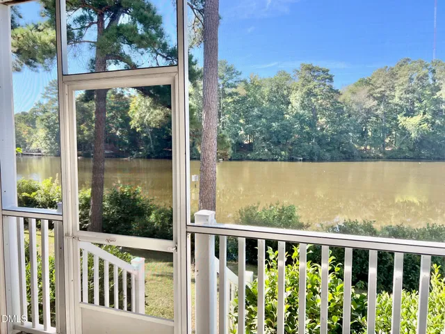 a view of a lake with houses in the back