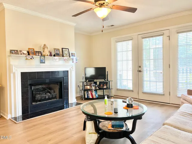 a living room with furniture a fireplace and a flat screen tv