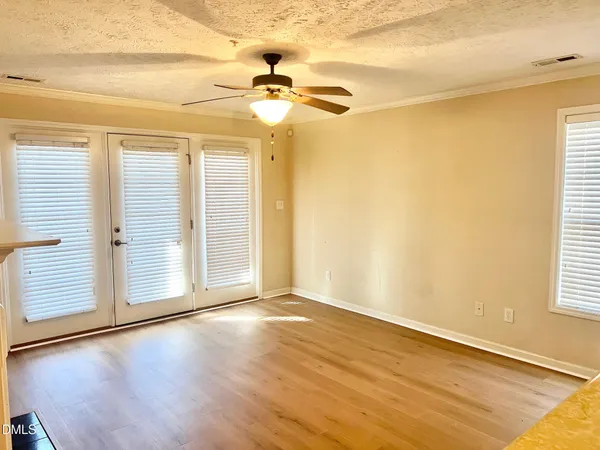 a view of a hallway with wooden floor and closet area