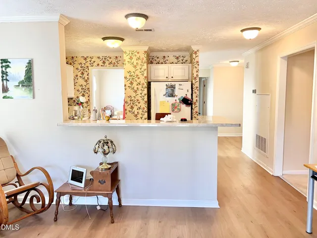 a dining room with furniture and wooden floor