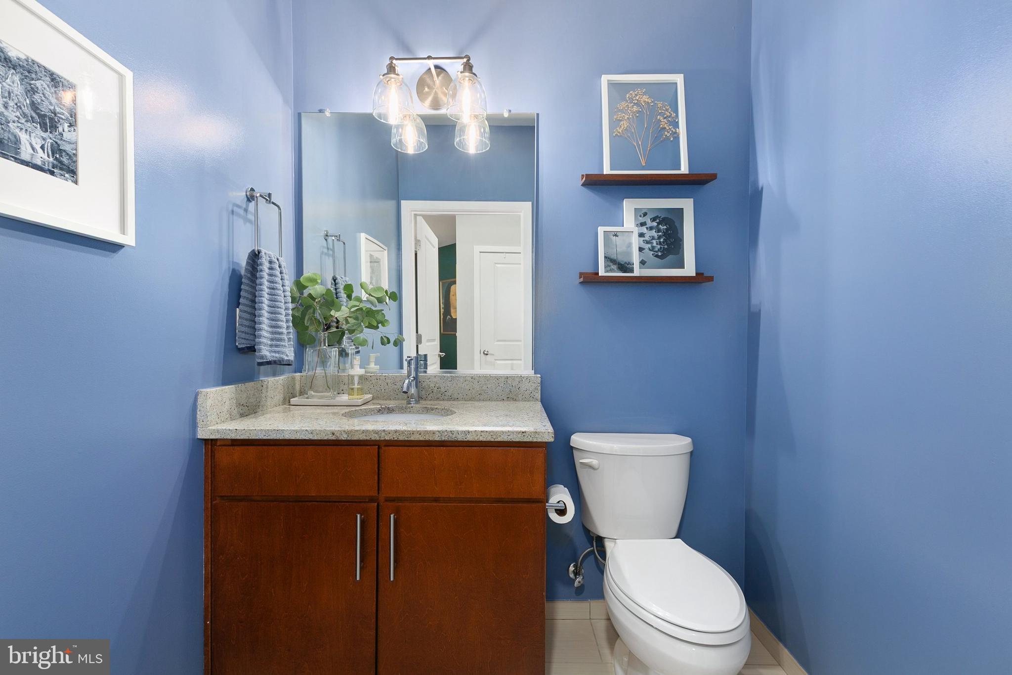 8005 13th Street, Unit 202 Silver Spring, MD 20910 - Photo 13 of 30 a bathroom with a toilet a sink and mirror