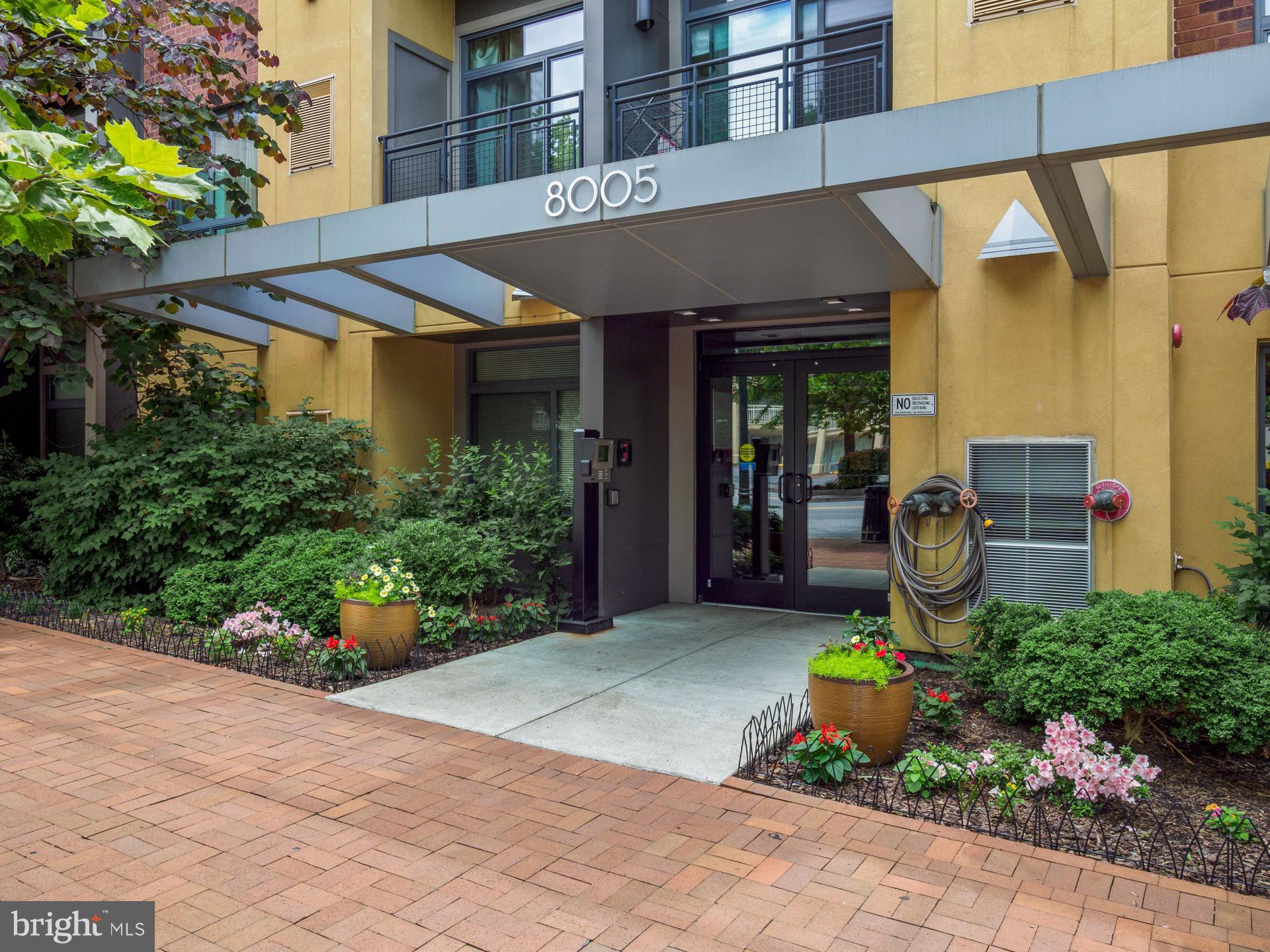 8005 13th Street, Unit 202 Silver Spring, MD 20910 - Photo 2 of 30 a front view of a building with garden