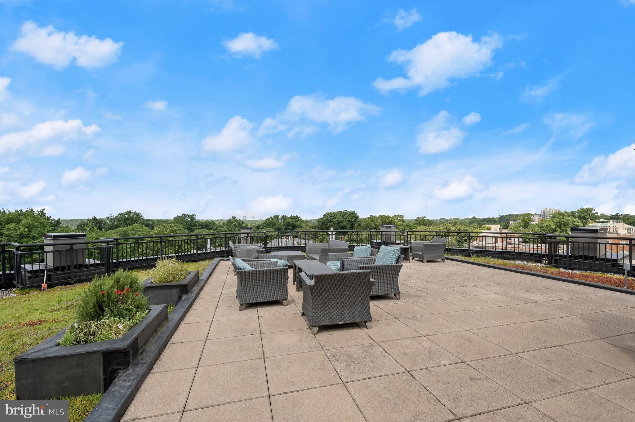 8005 13th Street, Unit 202 Silver Spring, MD 20910 - Photo 28 of 30 a terrace with outdoor seating and city view