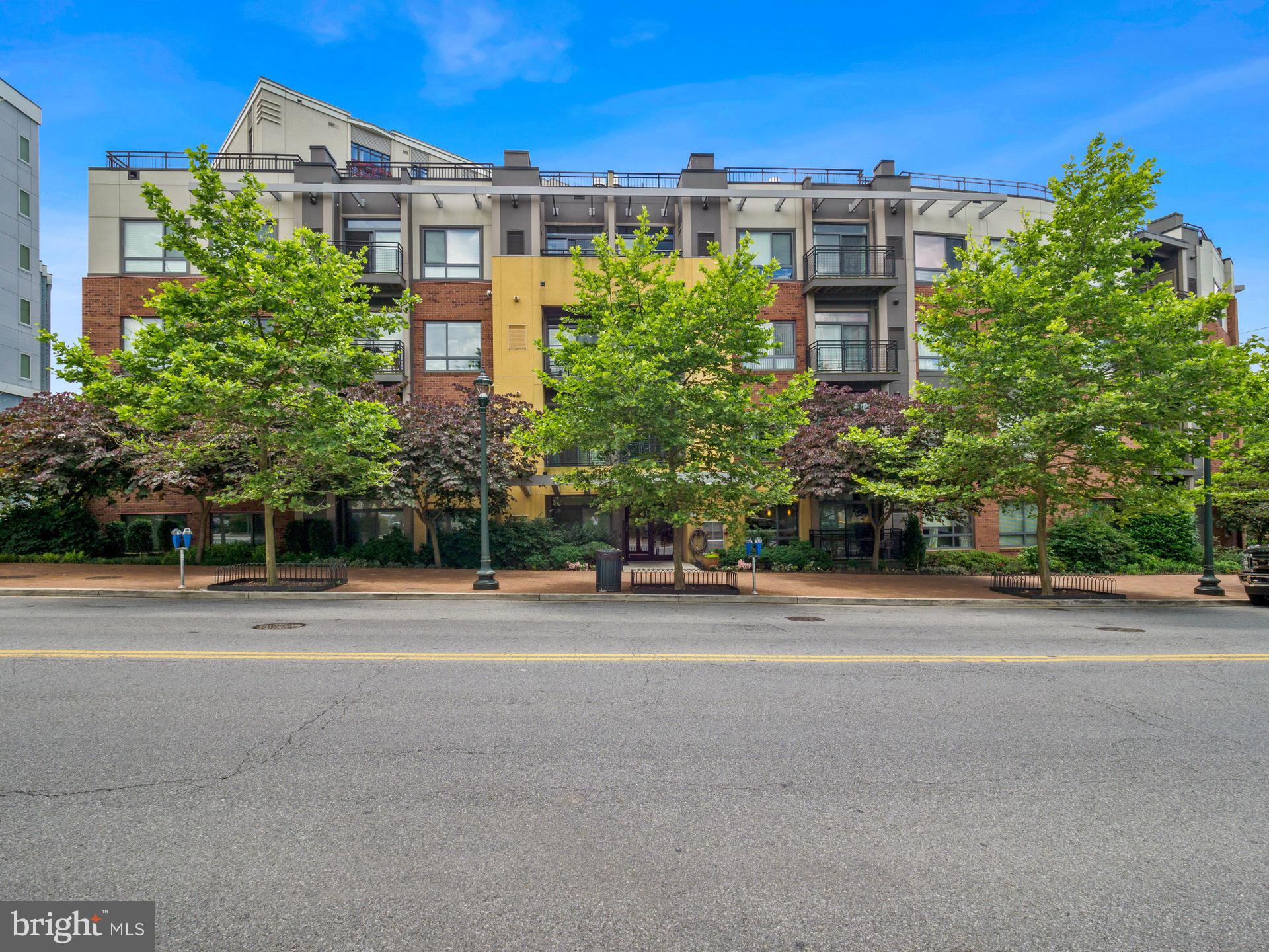 8005 13th Street, Unit 202 Silver Spring, MD 20910 - Photo 30 of 30 a front view of a multi story building with a yard