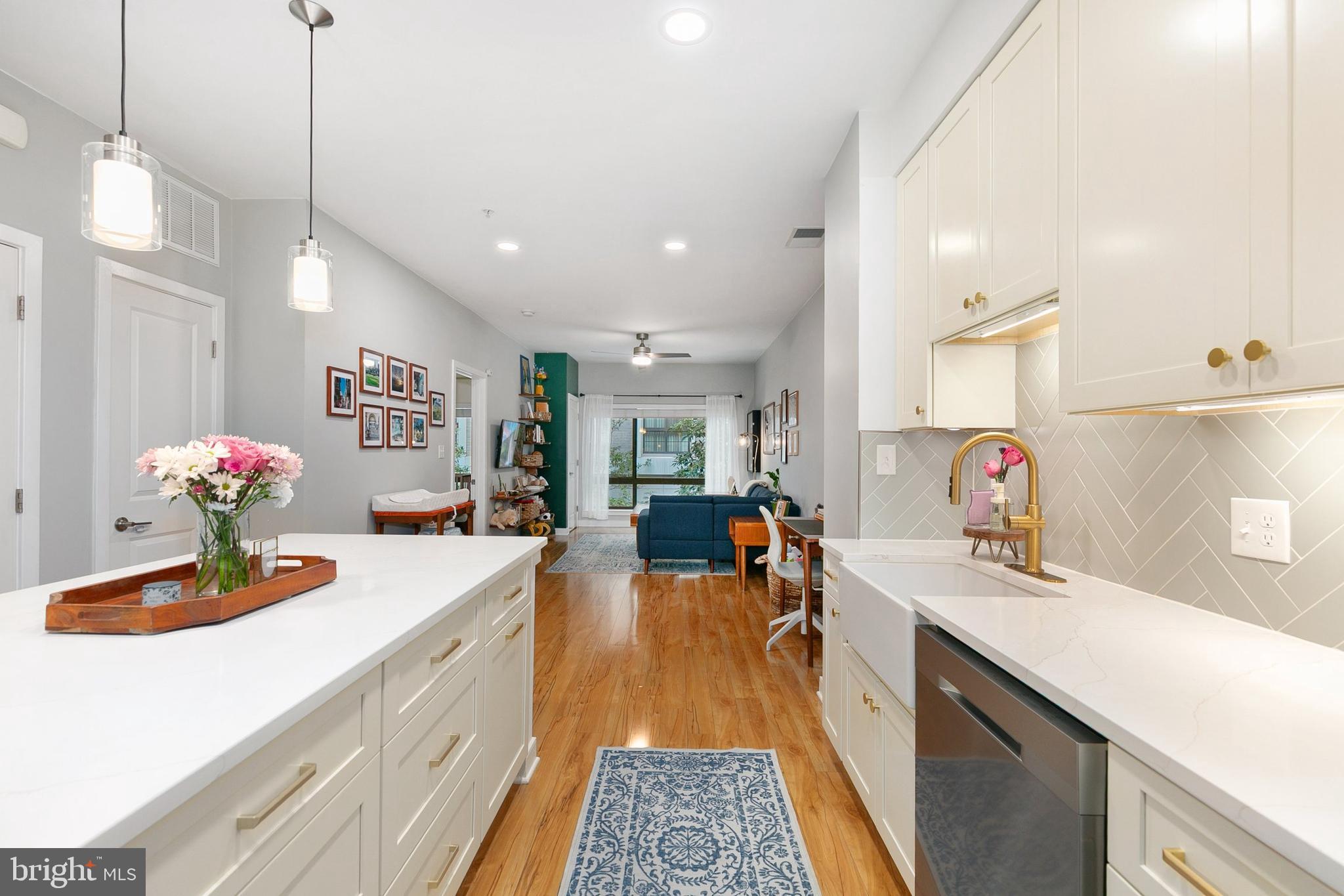 8005 13th Street, Unit 202 Silver Spring, MD 20910 - Photo 8 of 30 a kitchen with sink refrigerator and stove