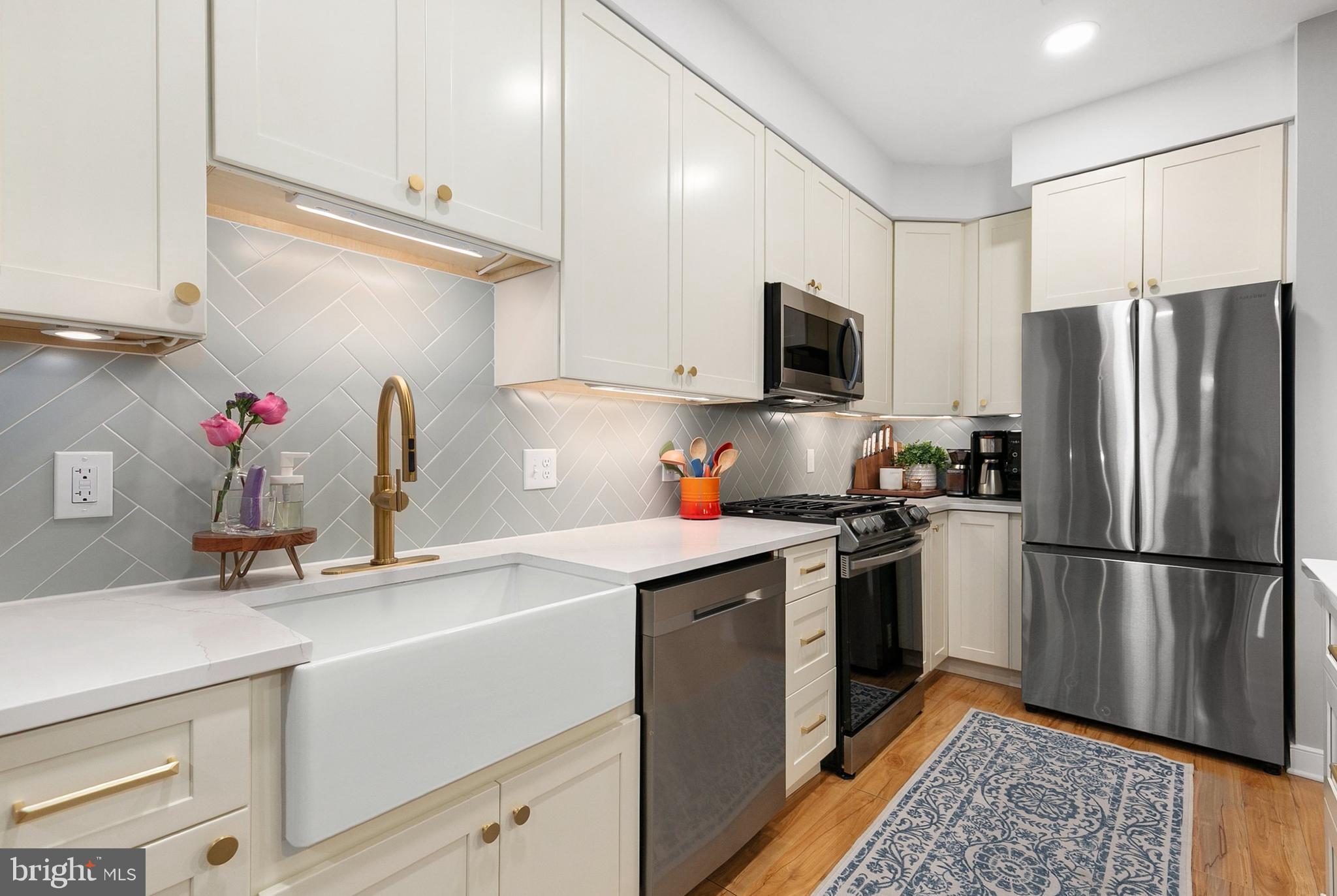 8005 13th Street, Unit 202 Silver Spring, MD 20910 - Photo 9 of 30 a kitchen with a sink stove and refrigerator