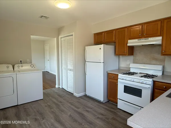 a kitchen with a stove a refrigerator and a sink