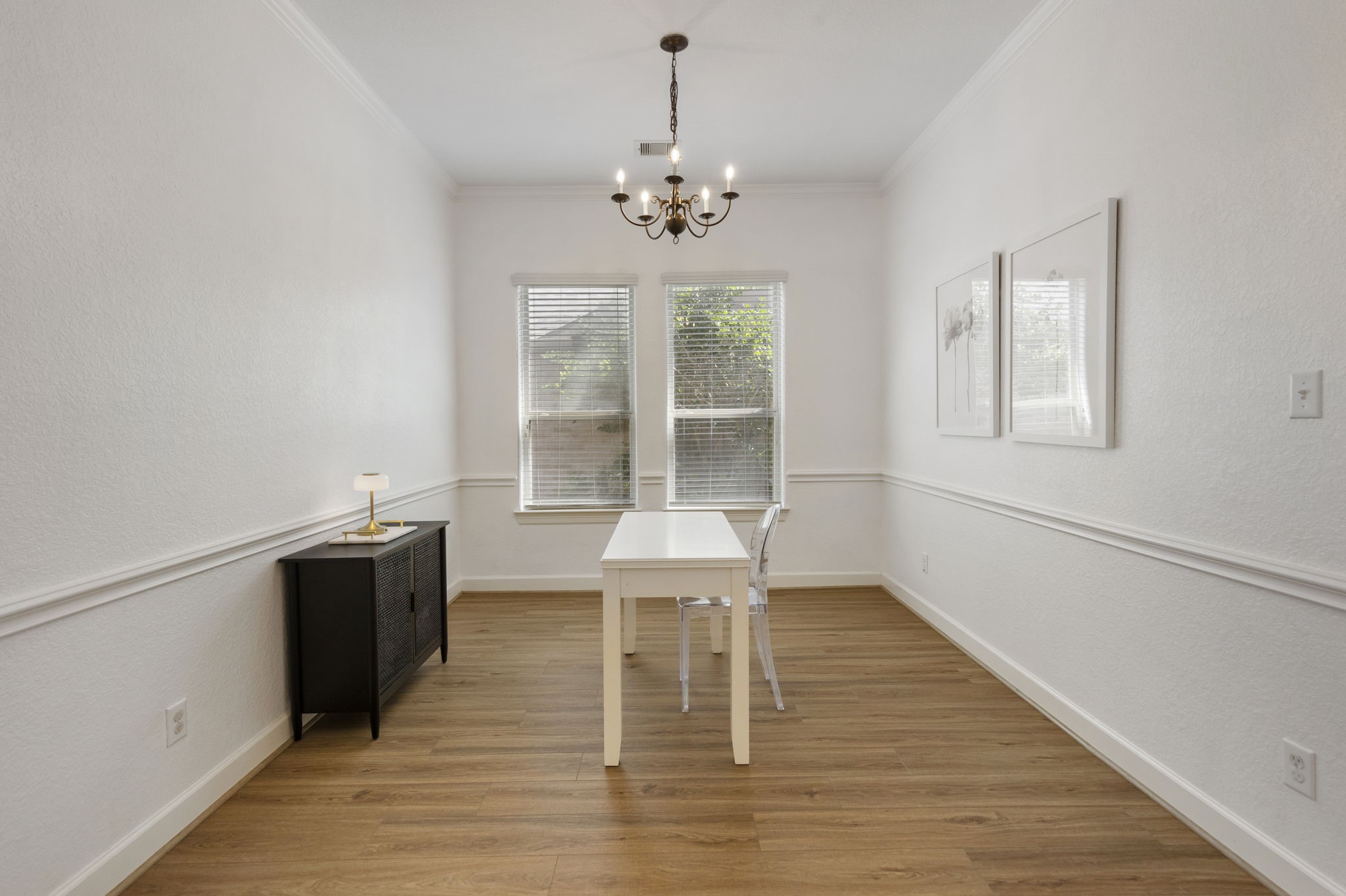 71 Sagamore Ridge Place The Woodlands, TX 77389 - Photo 7 of 34 a dining room with wooden floor and a chandelier