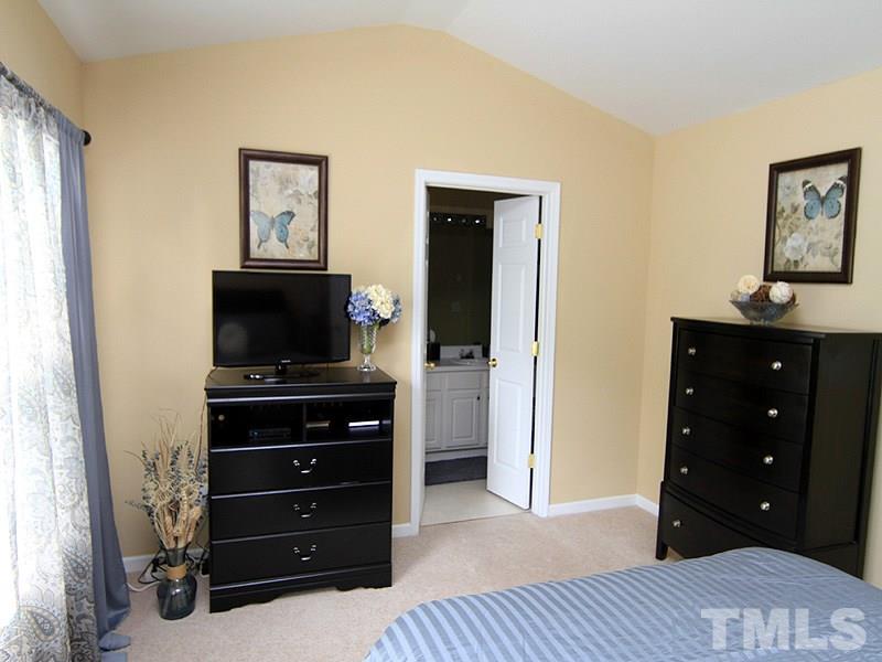 5349 Glen Canyon Road Raleigh, NC 27616 - Photo 9 of 14 a room with a dresser and a television