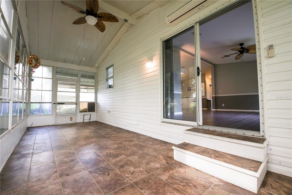 912 Orchid Street The Villages, FL 32159 - Photo 12 of 20 a view of a hallway with a chandelier