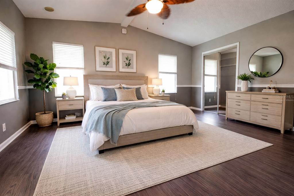 912 Orchid Street The Villages, FL 32159 - Photo 6 of 20 a bedroom with a bed lamp closet and large window