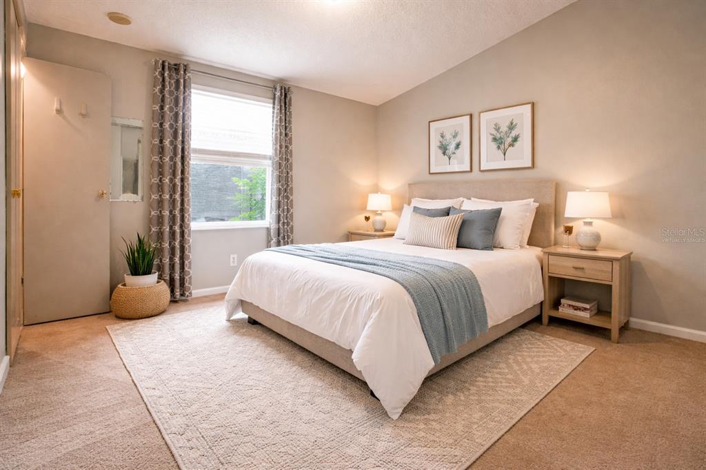 912 Orchid Street The Villages, FL 32159 - Photo 9 of 20 a bedroom with a bed a lamp and a large window