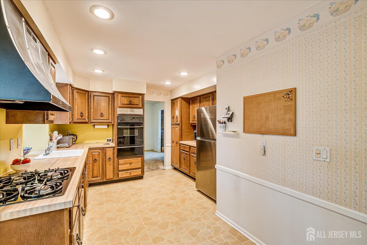 4 Bodnarik Road Edison, NJ 08837 - Photo 15 of 41 a kitchen with stainless steel appliances kitchen island granite countertop a refrigerator and a stove top oven