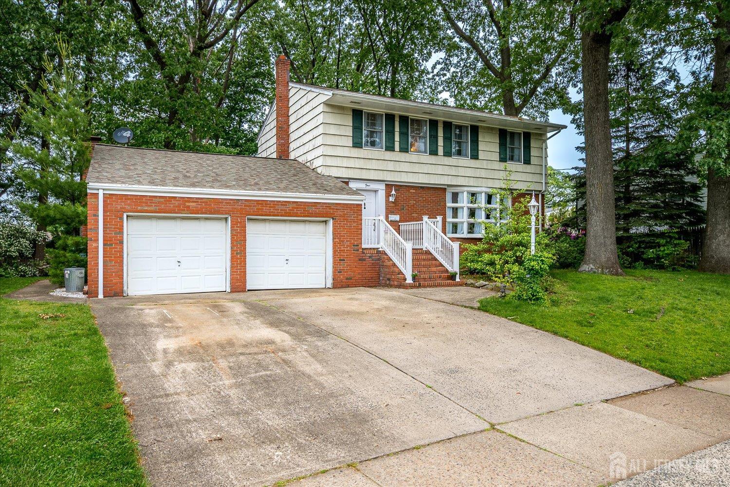 4 Bodnarik Road Edison, NJ 08837 - Photo 2 of 41 a front view of a house with a yard and garage